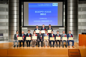 BCAOアワード2025表彰式で、特定非営利活動法人事業継続推進機構 理事長と受賞者が表彰状を手に記念撮影をしている様子